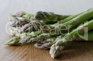 Close-up of fresh green asparagus on wooden background. angle vi