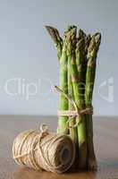 Close-up of fresh green asparagus wrapped with rope. side view