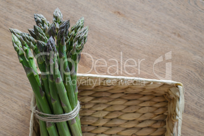 Close-up of fresh green asparagus wrapped with rope in the rusti