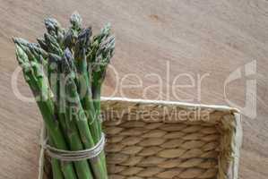 Close-up of fresh green asparagus wrapped with rope in the rusti