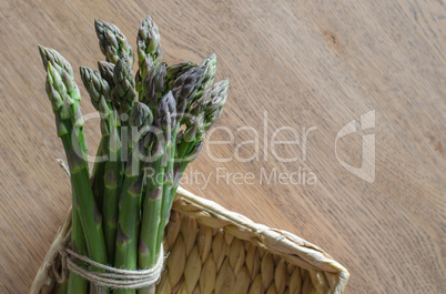 Close-up of fresh green asparagus wrapped with rope in the basket