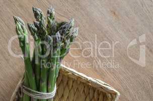 Close-up of fresh green asparagus wrapped with rope in the basket
