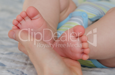 Close-up of mom hand holding baby feet