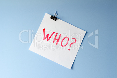 The word Who? on white paper sheet asking for help in solving a