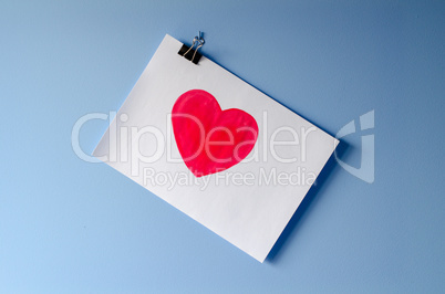 The painted red heart on white paper sheet love background