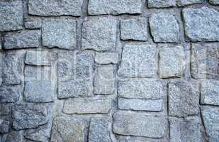 Wall of grey stones and concrete background texture