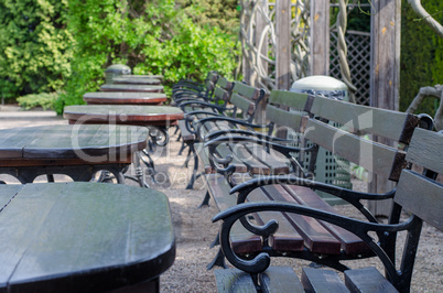 a number of empty benches and tables outside