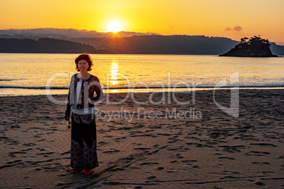 Woman at sunset at the sea