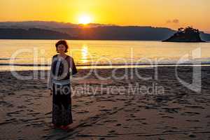 Woman at sunset at the sea