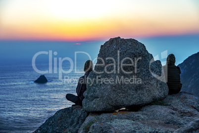 Person observes sunset at the sea