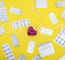 red heart and catheter on a yellow background