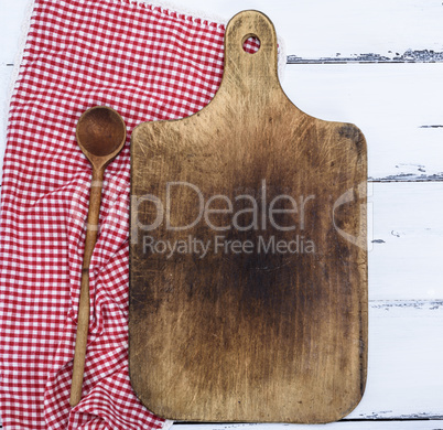 empty brown old kitchen cutting board and wooden spoon