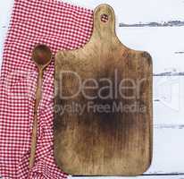 empty brown old kitchen cutting board and wooden spoon