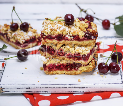 stack of baked slices of a pie with cherry berries