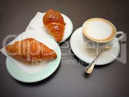 Morning breakfast with cappuccino and croissants