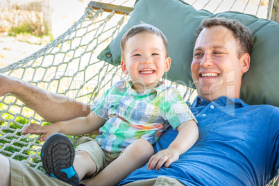 Caucasian Father Relaxing In Hammock with Mixed Race Chinese Son