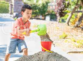 Young Caucasian and Chinese Boy Playing with Shovel and Bucket