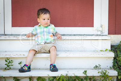 Young Mixed Race Chinese and Caucasian Boy Relaxing On The Steps