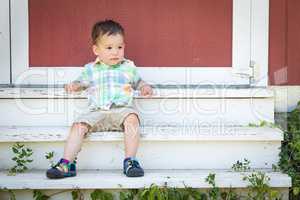 Young Mixed Race Chinese and Caucasian Boy Relaxing On The Steps