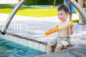 Young Mixed Race Chinese and Caucasian Boy Playing At The Pool