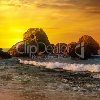 Sea landscape with rocky island and the sunrise.