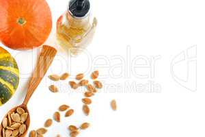 Fresh pumpkin oil isolated on white background. Flat lay, top vi