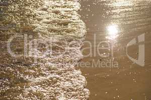 surf of the Baltic sea with evening sun