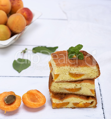 baked square pieces of a sponge cake with fresh apricots