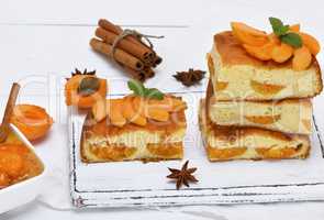 square pieces of cake sponges with fresh apricots