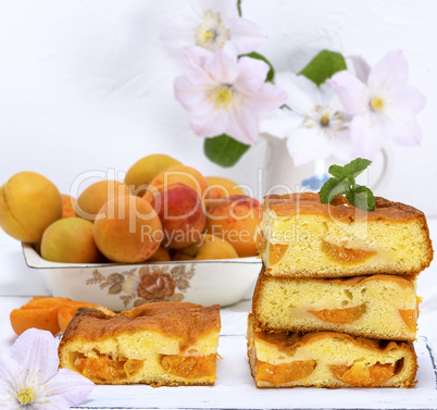 stack of biscuit pie with apricots on a white wooden table