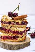 stack of baked slices of a pie with cherry berries