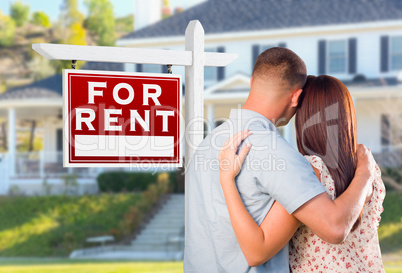 Military Couple Looking At House with For Rent Real Estate Sign