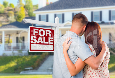 Military Couple Looking At House with For Sale Real Estate Sign