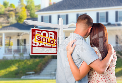 Military Couple Looking At House with Sold For Sale Real Estate