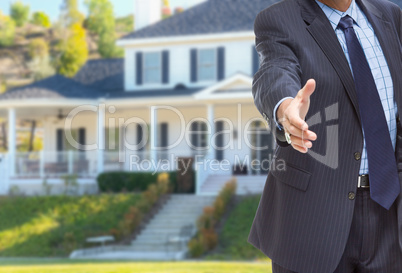 Male Agent Reaching for Hand Shake in Front of Beautiful New Hou