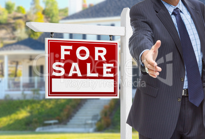Male Agent Reaching for Hand Shake in Front of For Sale Sign and