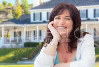 Attractive Middle Aged Woman Relaxing In Front Yard of Beautiful