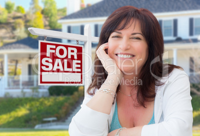 Middle Aged Woman In Front of House with For Sale Real Estate Si