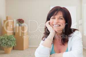 Middle Aged Woman Relaxing Inside Empty Room With Moving Boxes