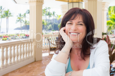 Attractive Middle Aged Woman Relaxing On Patio In A Tropical Tra