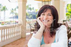 Attractive Middle Aged Woman Relaxing On Patio In A Tropical Tra