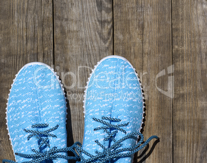 pair of blue textile shoes, top view