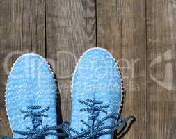 pair of blue textile shoes, top view