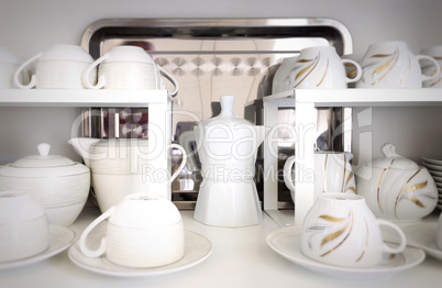 Cups on the white shelves