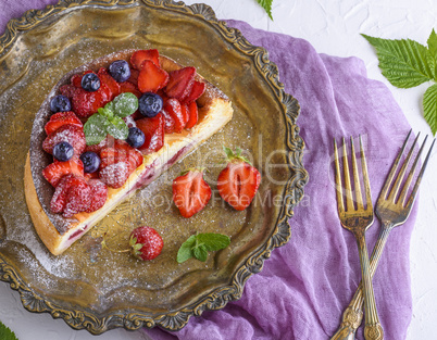cheesecake with strawberries on an iron copper plate
