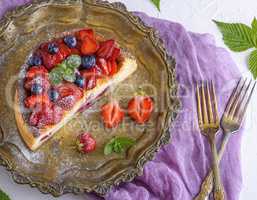 cheesecake with strawberries on an iron copper plate