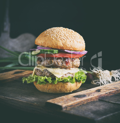 cheeseburger on a brown wooden board