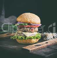 cheeseburger on a brown wooden board
