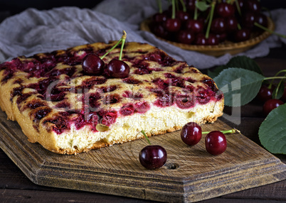 piece of biscuit cherry pie on a brown wooden board