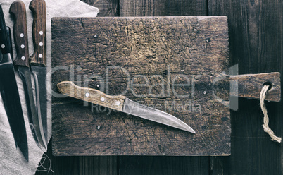 knives and brown wooden cutting board